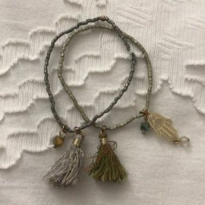 Simply beaded bracelet with tassels and hamsa.